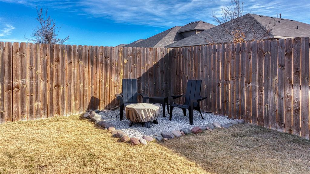2429 Goodnight Ranch Drive Weatherford, TX 76087 - Photo 31 of 32 a view of a backyard with a patio and wooden fence