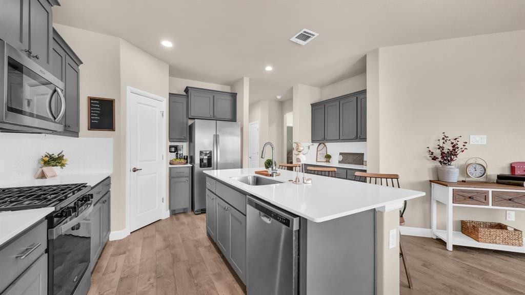 2429 Goodnight Ranch Drive Weatherford, TX 76087 - Photo 5 of 32 a kitchen with a sink stove and cabinets