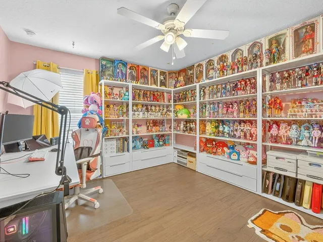 a view of an empty room with workspace and toys