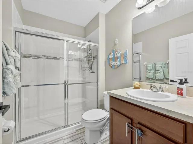 a bathroom with a sink a toilet and mirror