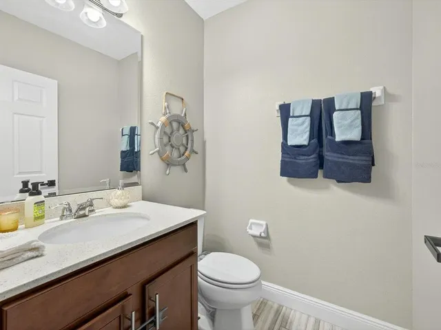 a view of a house with a yard and a large tree