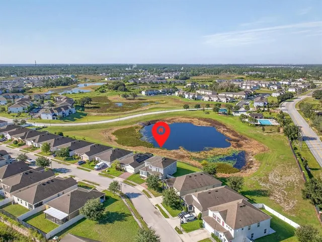 an aerial view of residential building and lake