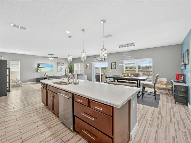 a kitchen with a stove and a wooden floor