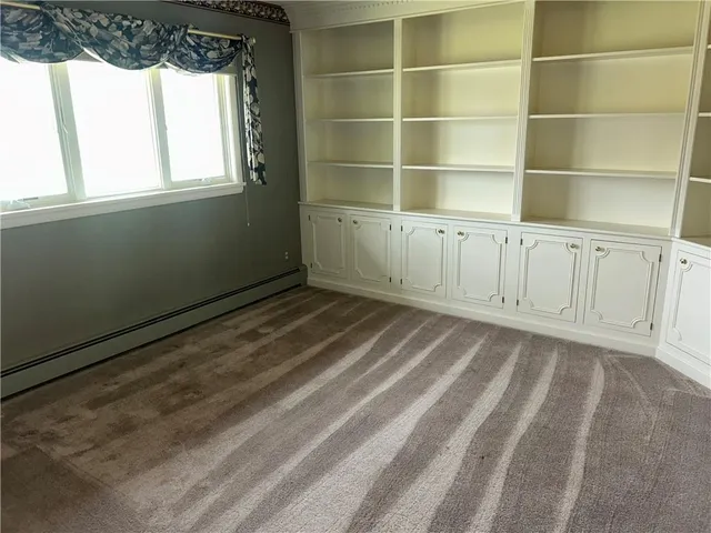 a view of a room with rack on the wall and a window