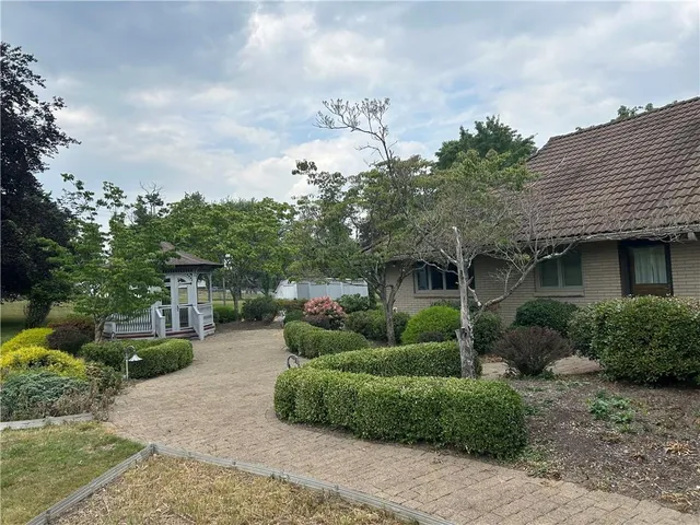 a backyard of a house with a garden and plants