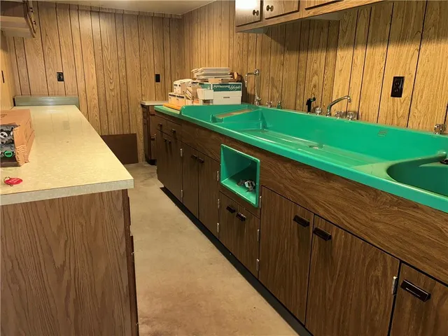 a kitchen with a refrigerator and a sink