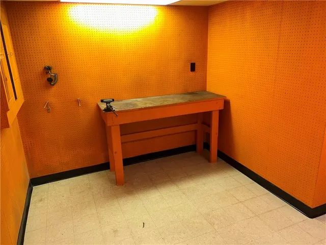 a bathroom with a granite countertop sink and a toilet