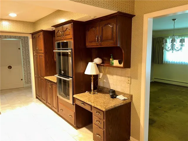 a kitchen with stainless steel appliances granite countertop a sink and a refrigerator