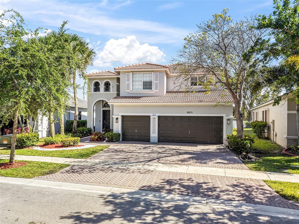 a front view of a house with a yard and garage
