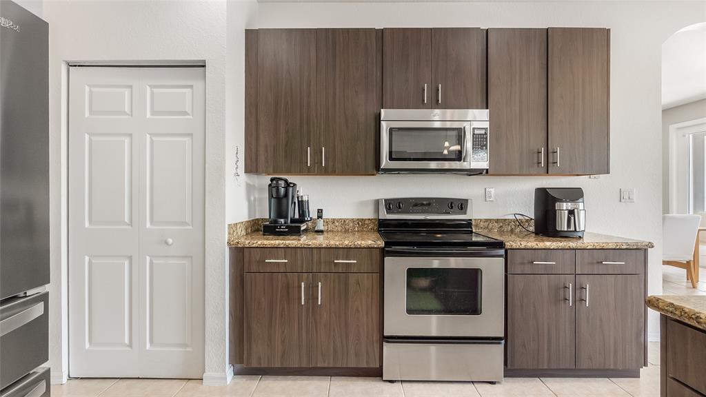 19470 Stonebrook Street Weston, FL 33332 - Photo 12 of 44 a kitchen with a stove and a microwave