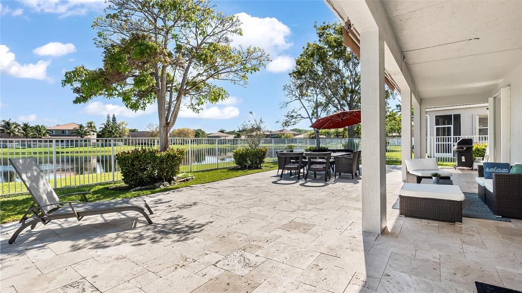 19470 Stonebrook Street Weston, FL 33332 - Photo 18 of 44 a view of a swimming pool with a patio and a garden