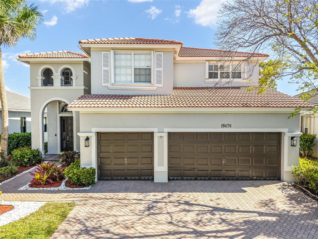 19470 Stonebrook Street Weston, FL 33332 - Photo 19 of 44 a front view of a house with garden