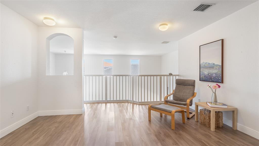 19470 Stonebrook Street Weston, FL 33332 - Photo 21 of 44 an empty room with wooden floor and windows
