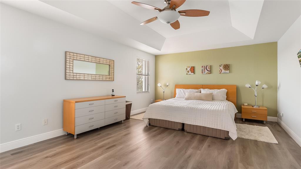 19470 Stonebrook Street Weston, FL 33332 - Photo 23 of 44 a bedroom with a bed and a chandelier