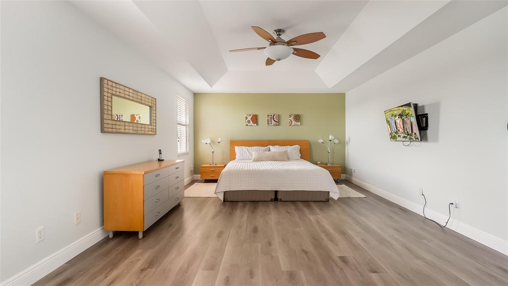 19470 Stonebrook Street Weston, FL 33332 - Photo 24 of 44 a spacious bedroom with a bed and wooden floor