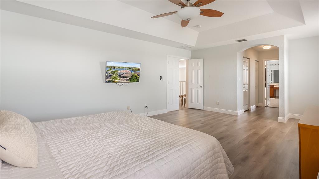 19470 Stonebrook Street Weston, FL 33332 - Photo 25 of 44 a bedroom with a large bed and a chandelier