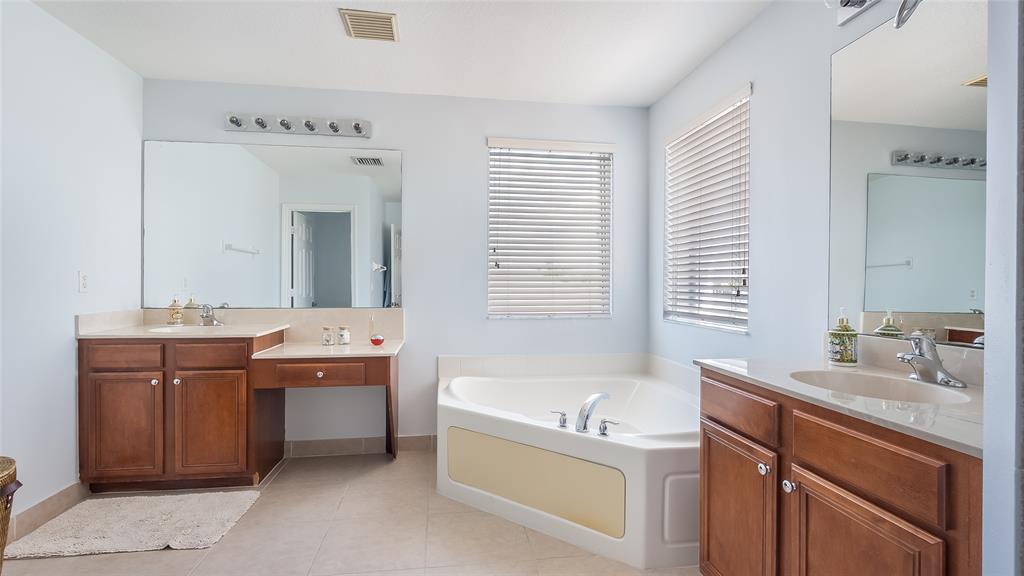 19470 Stonebrook Street Weston, FL 33332 - Photo 26 of 44 a bathroom with a tub sink and mirror