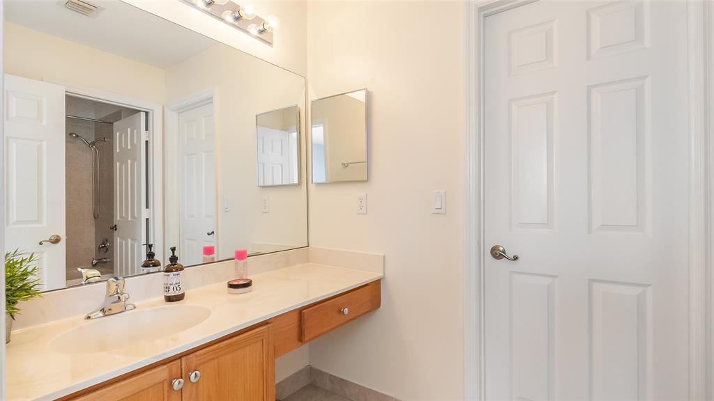 19470 Stonebrook Street Weston, FL 33332 - Photo 32 of 44 a bathroom with a sink vanity and mirror