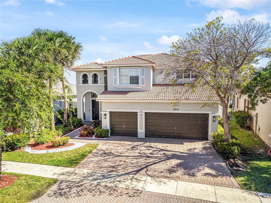 19470 Stonebrook Street Weston, FL 33332 - Photo 43 of 44 a front view of a house with a yard and garage