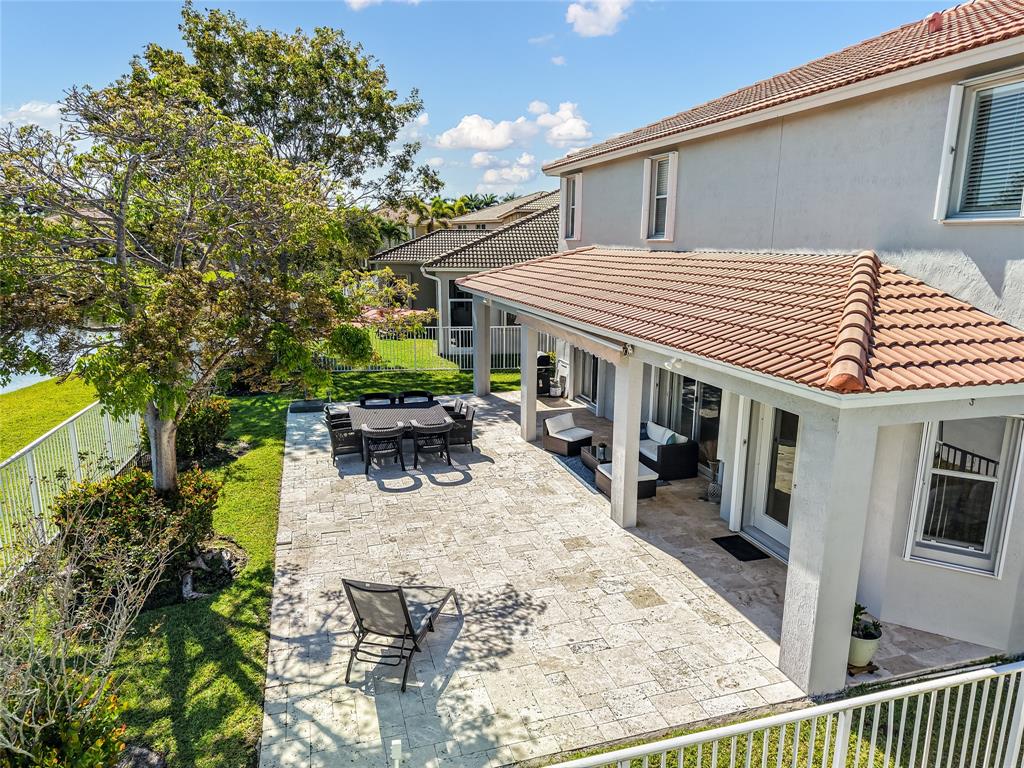 19470 Stonebrook Street Weston, FL 33332 - Photo 44 of 44 a view of a patio with table and chairs and potted plants