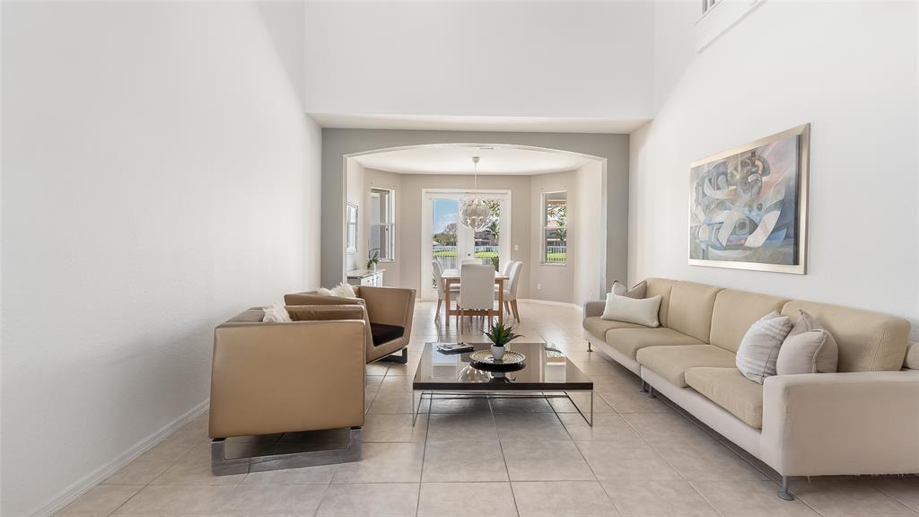 19470 Stonebrook Street Weston, FL 33332 - Photo 5 of 44 a living room with furniture and a large window