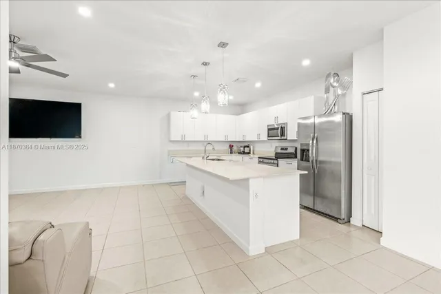 a large white kitchen with a large window