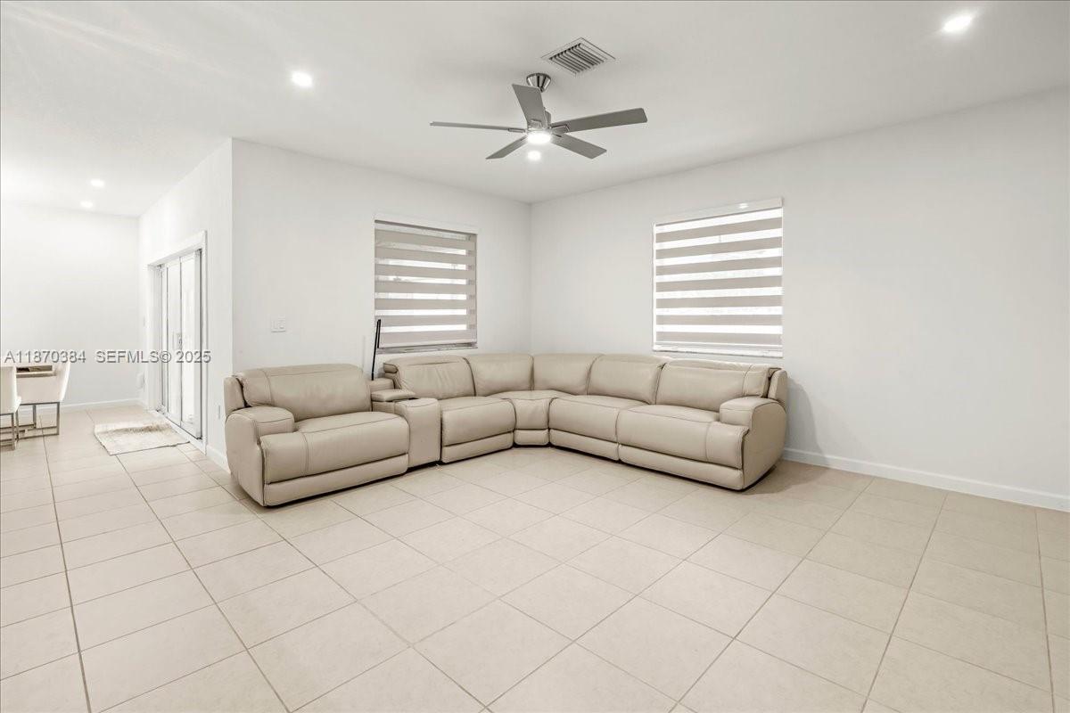 19803 Southwest 321st Street Homestead, FL 33030 - Photo 20 of 48 a living room with furniture and a large window