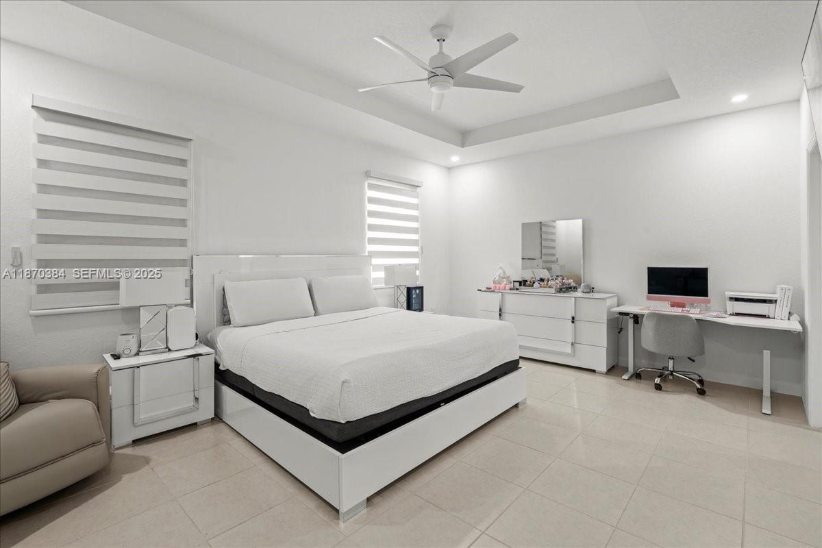 19803 Southwest 321st Street Homestead, FL 33030 - Photo 22 of 48 a spacious bedroom with a bed and a desk