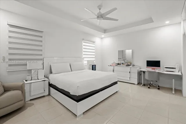 a spacious bedroom with a bed and a couch