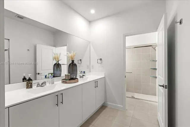 a bathroom with a double vanity sink mirror and double