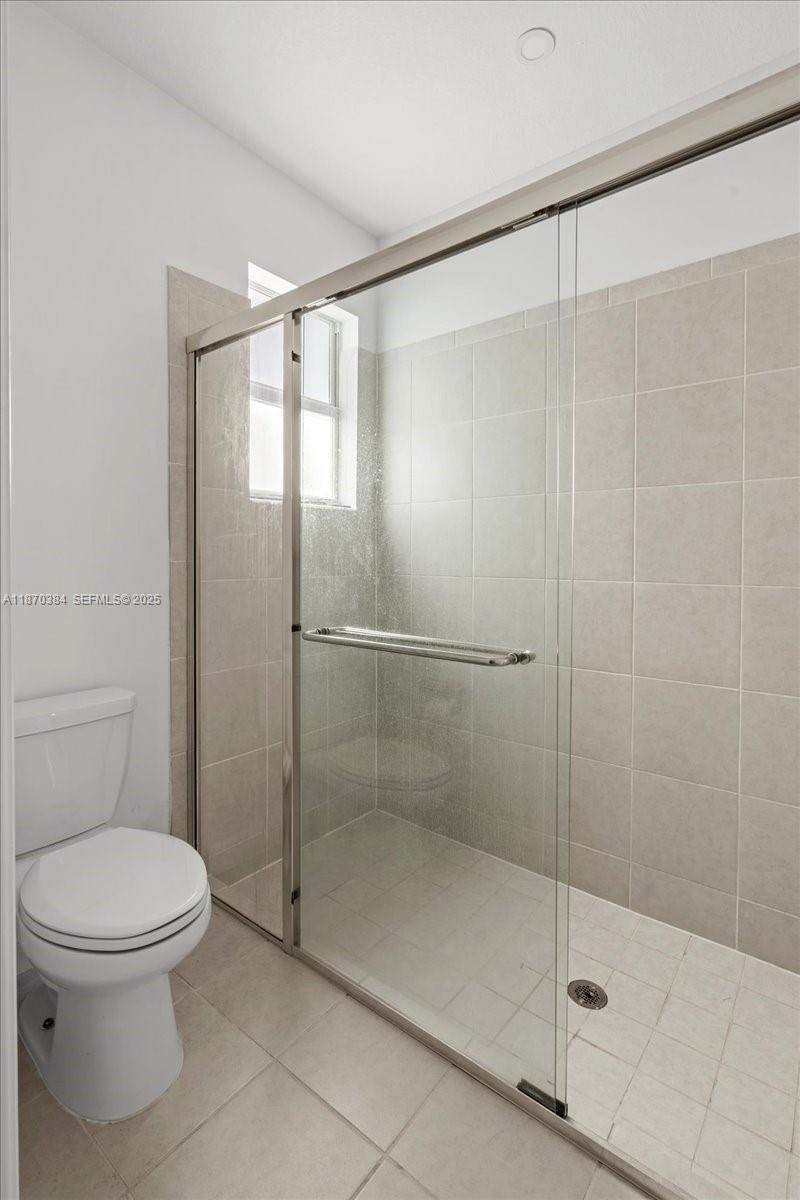 19803 Southwest 321st Street Homestead, FL 33030 - Photo 25 of 48 a bathroom with a shower and a toilet