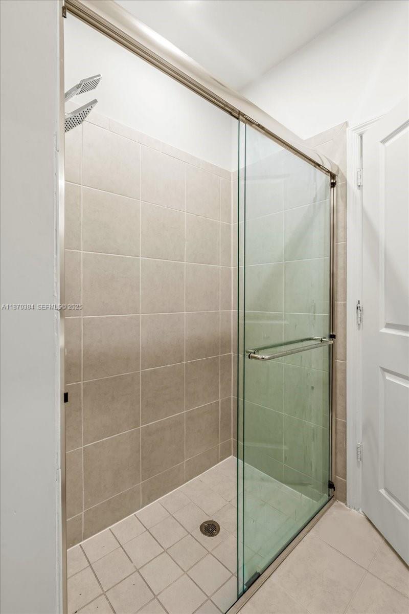 19803 Southwest 321st Street Homestead, FL 33030 - Photo 30 of 48 a bathroom with a glass shower door