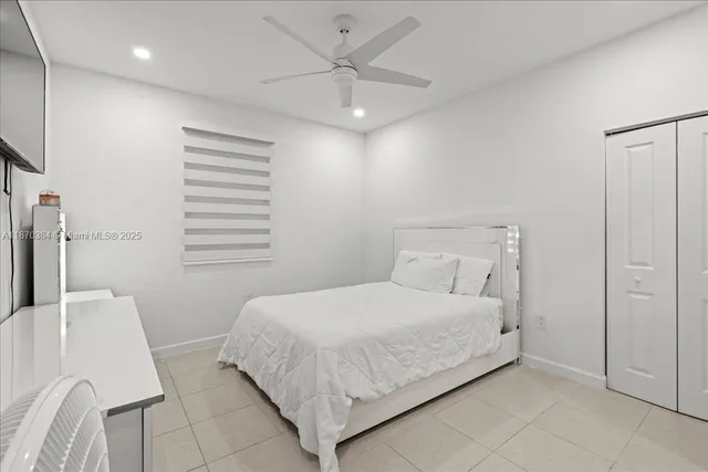 a bedroom with a bed and a ceiling fan