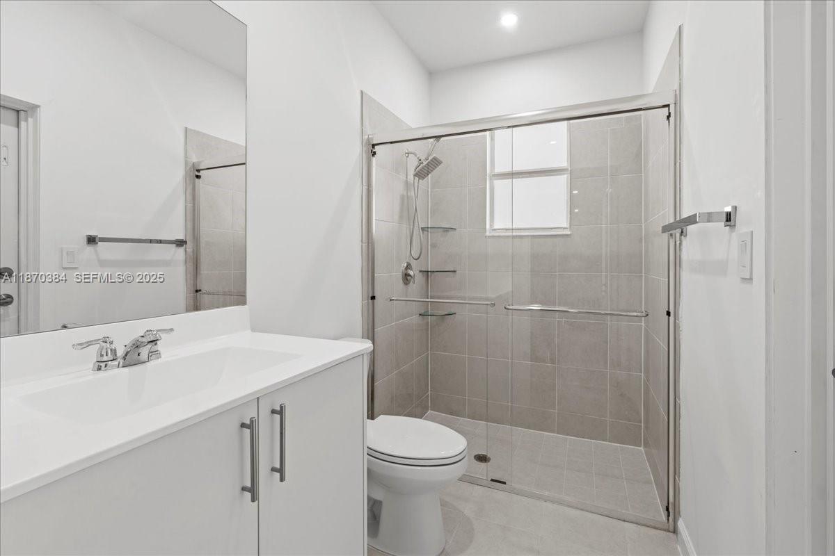 19803 Southwest 321st Street Homestead, FL 33030 - Photo 35 of 48 a bathroom with a sink toilet and shower