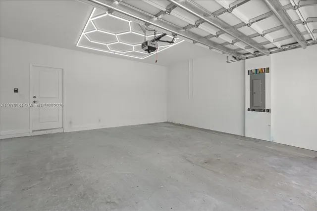 a living room with stainless steel appliances kitchen island granite countertop furniture a fireplace and a flat screen tv