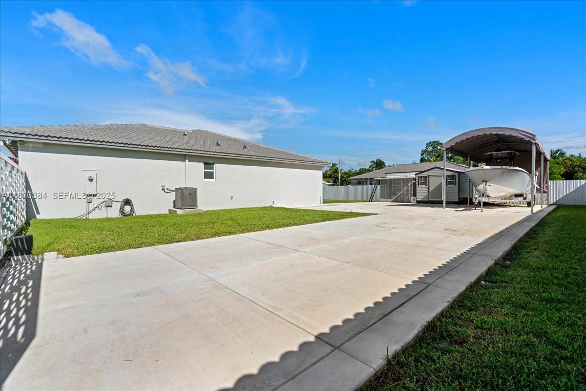 19803 Southwest 321st Street Homestead, FL 33030 - Photo 47 of 48 a front view of a house with a yard and garage