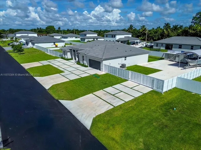 an aerial view of a house with garden space and street view