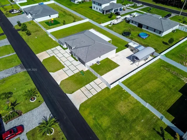 an aerial view of a tennis ground and a cars park