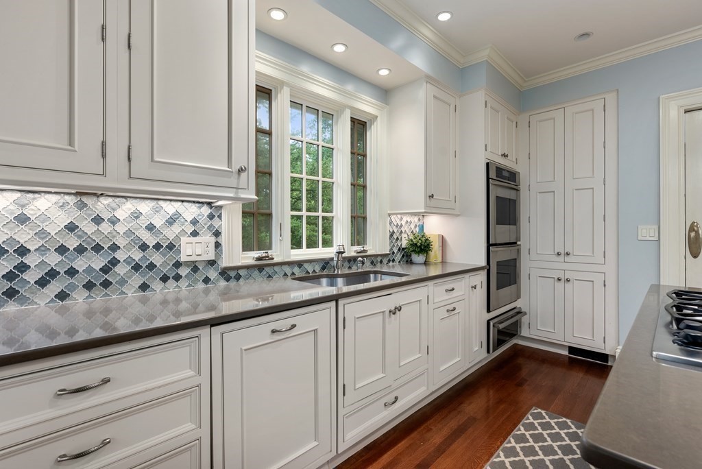 19 Burnham Road Newton, MA 02465 - Photo 11 of 30 a kitchen with granite countertop white cabinets and sink