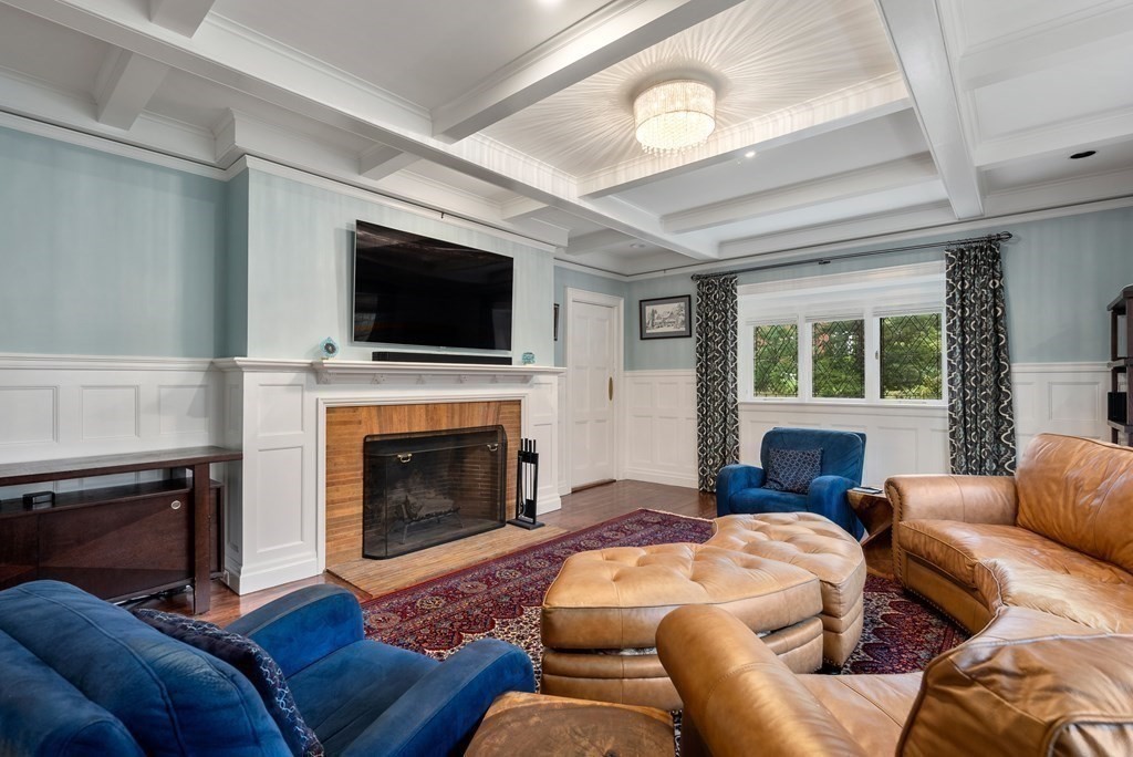 19 Burnham Road Newton, MA 02465 - Photo 15 of 30 a living room with furniture a fireplace and a flat screen tv