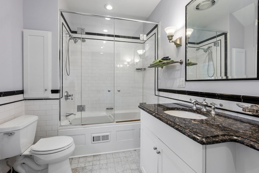 19 Burnham Road Newton, MA 02465 - Photo 22 of 30 a bathroom with a granite countertop sink mirror vanity and toilet