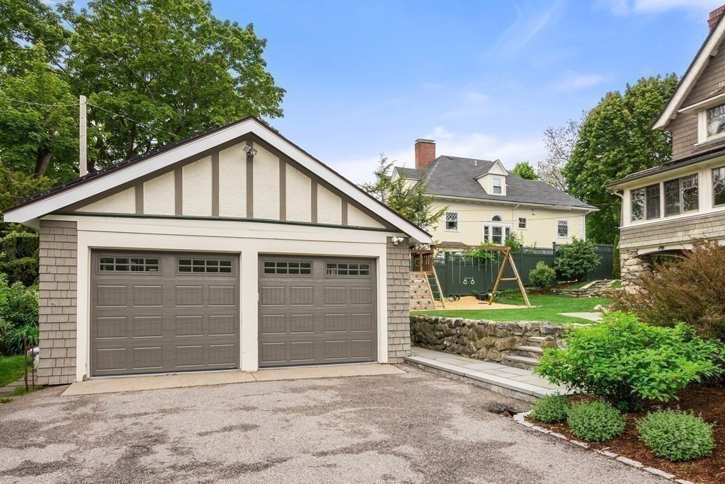 19 Burnham Road Newton, MA 02465 - Photo 26 of 30 a front view of a house with a yard and garage