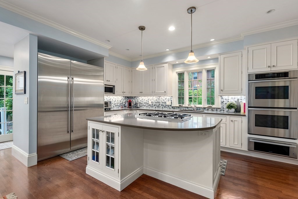 19 Burnham Road Newton, MA 02465 - Photo 10 of 30 a kitchen with kitchen island granite countertop a sink cabinets and stainless steel appliances