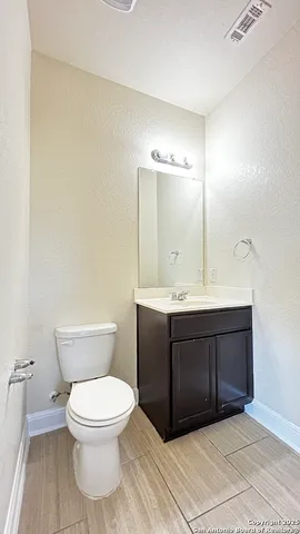 a bathroom with a sink a toilet and mirror
