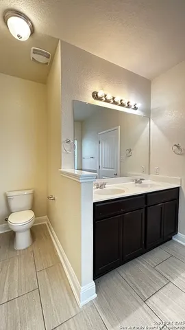 a spacious bathroom with a bathtub sink mirror and toilet