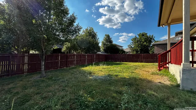 a view of house with backyard