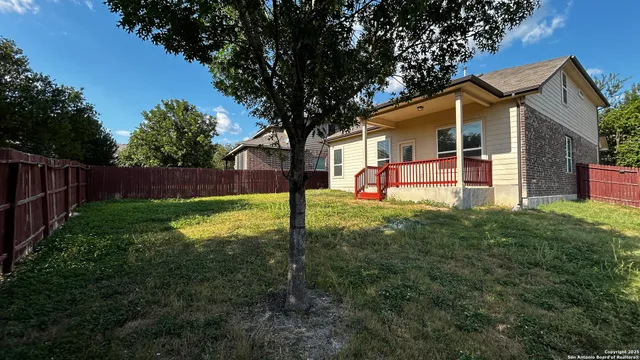 a view of a house with a backyard and a patio