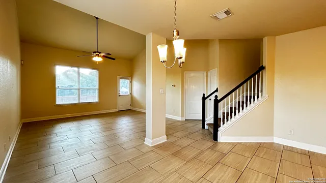 a view of a room with window and chandelier