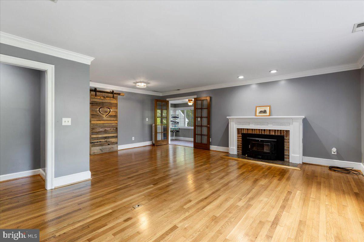1100 Plum Point Road Huntingtown, MD 20639 - Photo 4 of 52 LIVING ROOM W/FIREPLACE/WOOD STOVE