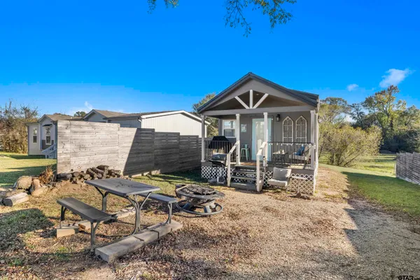a view of a house with a yard and sitting area